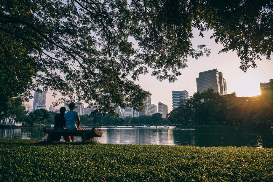 a couple looking at tall buildings across the lake